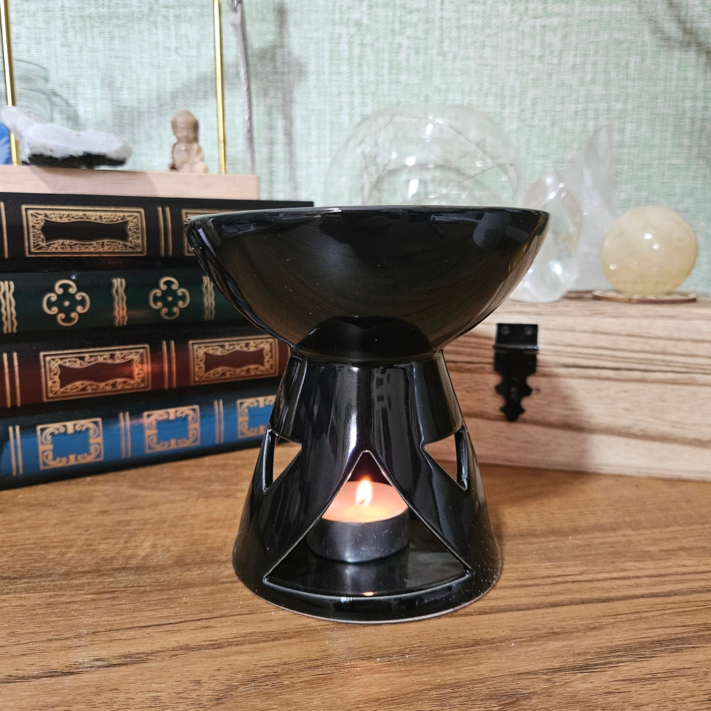 Glossy black ceramic wax melt and fragrance oil burner with tealight holder.