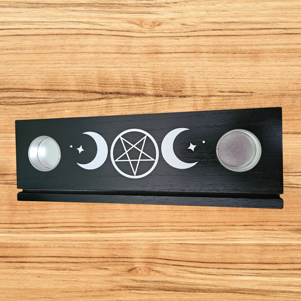 Black wooden Triple Moon tarot card holder with pentacle design, three tarot cards and two tealight holders.