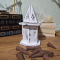 Distressed white wooden incense cone burner with hexagonal base, hinged pyramid lid and decorative smoke vents.