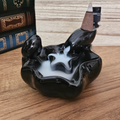Black ceramic waterfall backflow incense burner with white incense smoke cascading into the lower pool.
