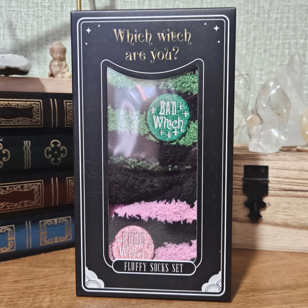 Boxed set of Good Witch pink and black and Bad Witch green and black fluffy striped socks.