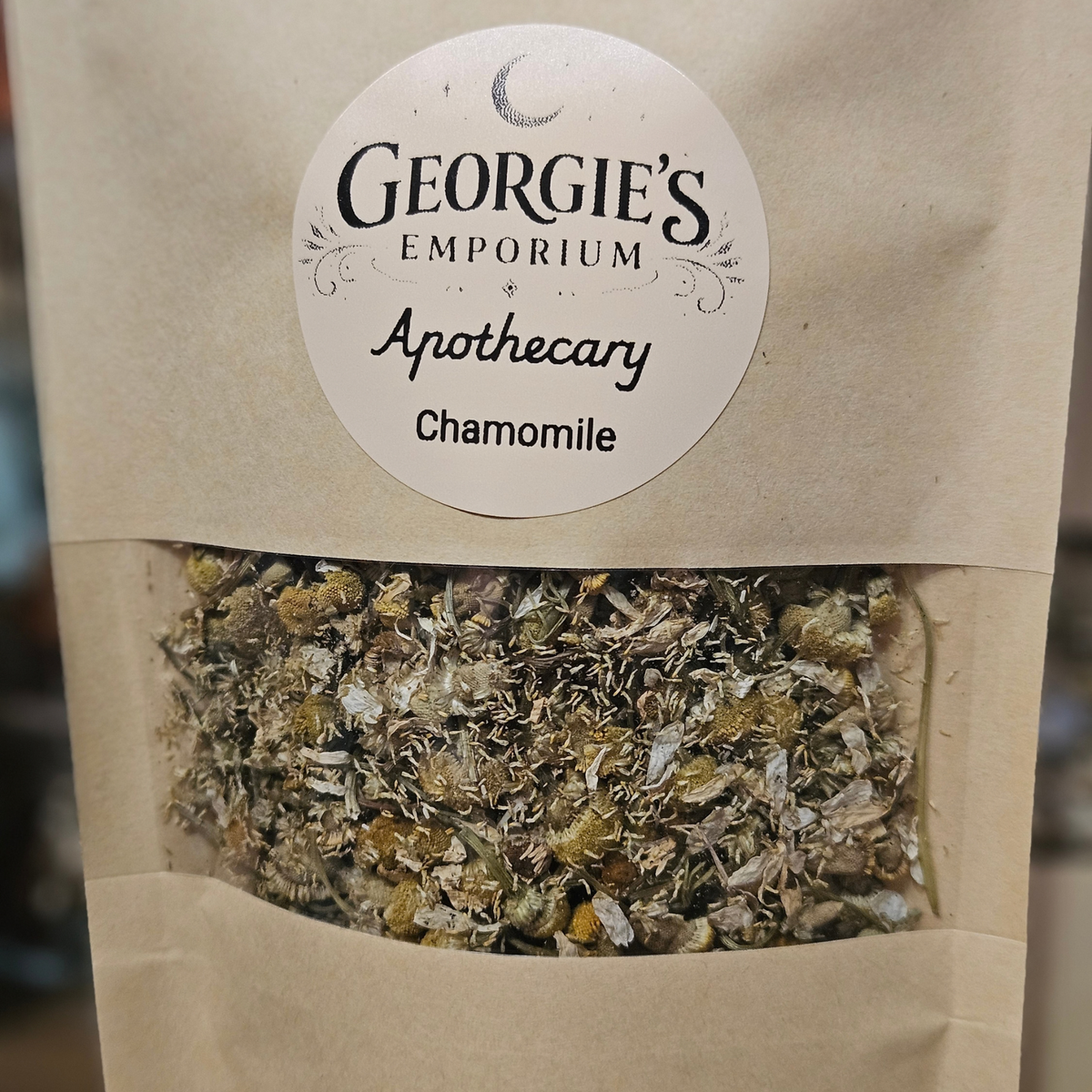 Close-up of 20g dried chamomile flowers in Georgie's Apothecary kraft pouch