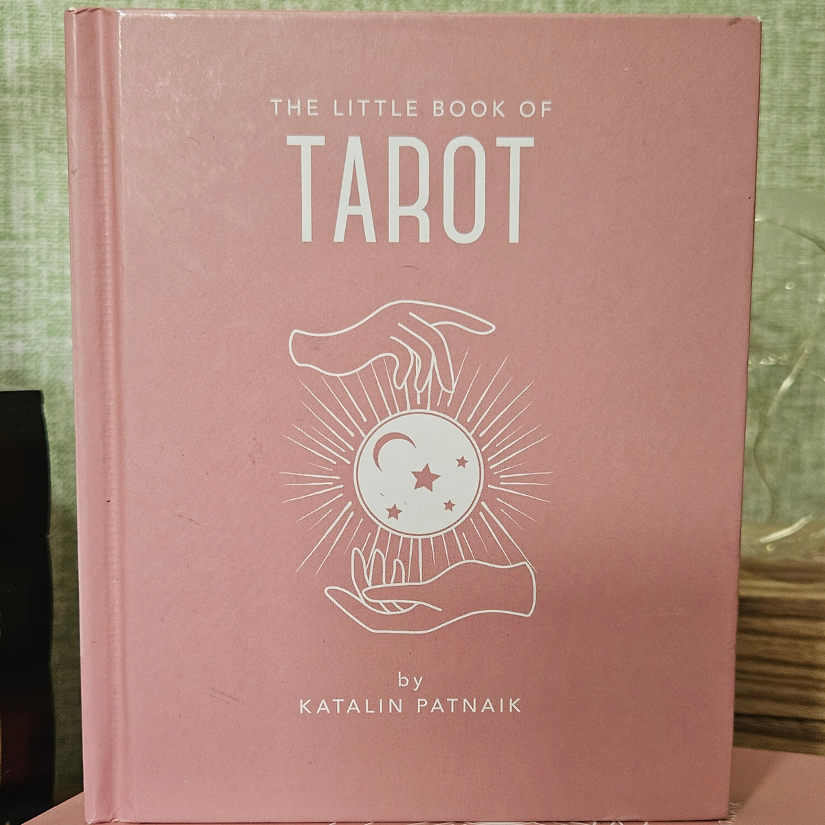 Pink hardback copy of The Little Book of Tarot by Katalin Patnaik.