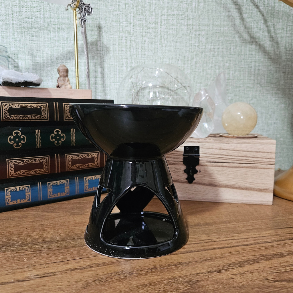 Glossy black ceramic wax melt and fragrance oil burner with tealight holder.