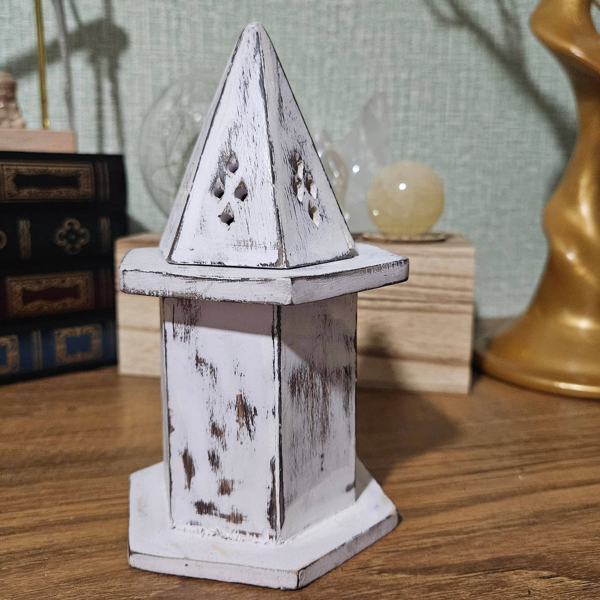 Distressed white wooden incense cone burner with hexagonal base, hinged pyramid lid and decorative smoke vents.