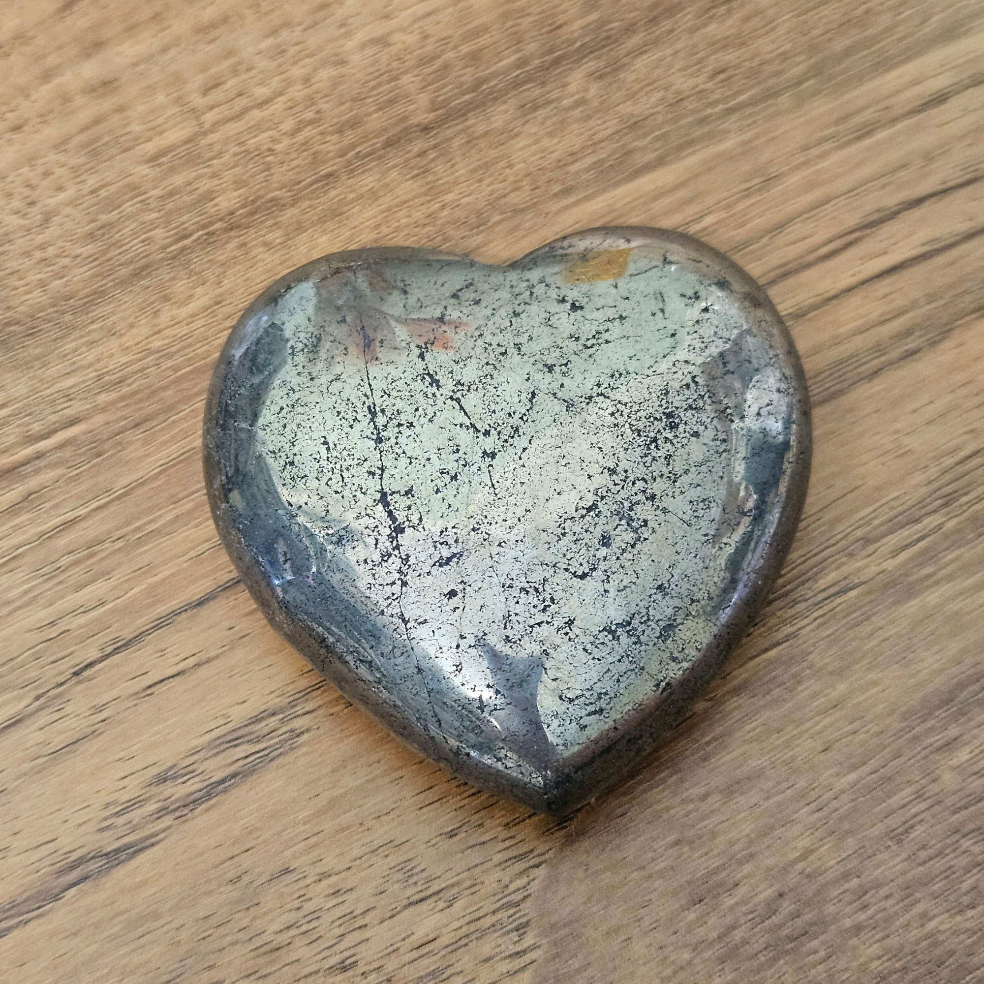 Polished 6cm Pyrite crystal heart with metallic golden bronze colouring and natural markings.