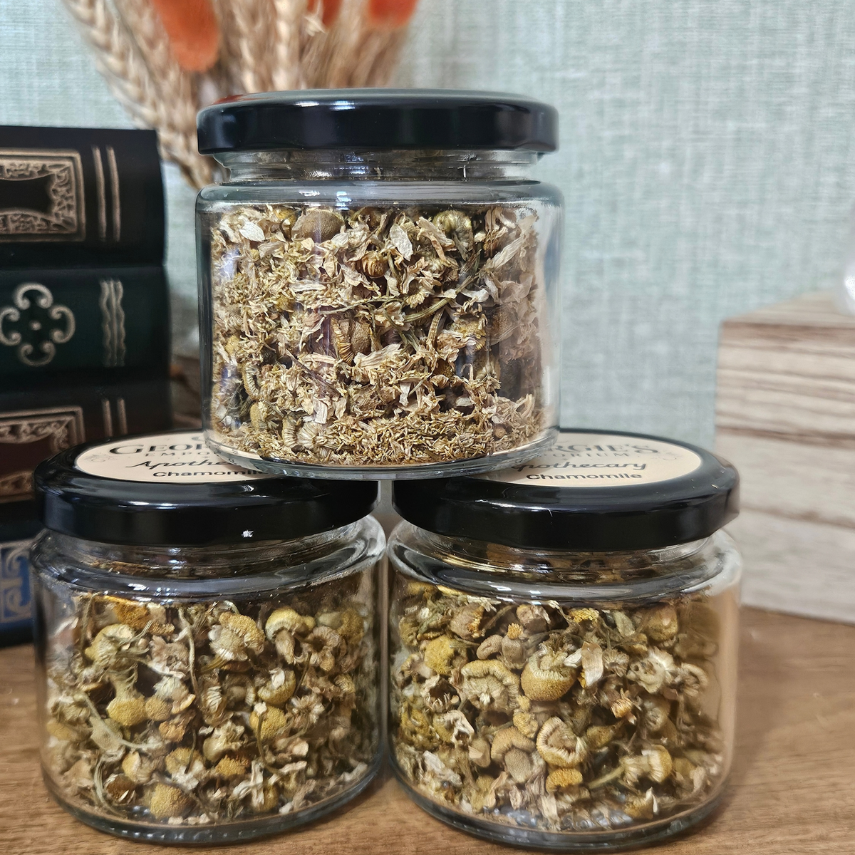 Three glass jars of dried chamomile flowers from Georgie's Apothecary