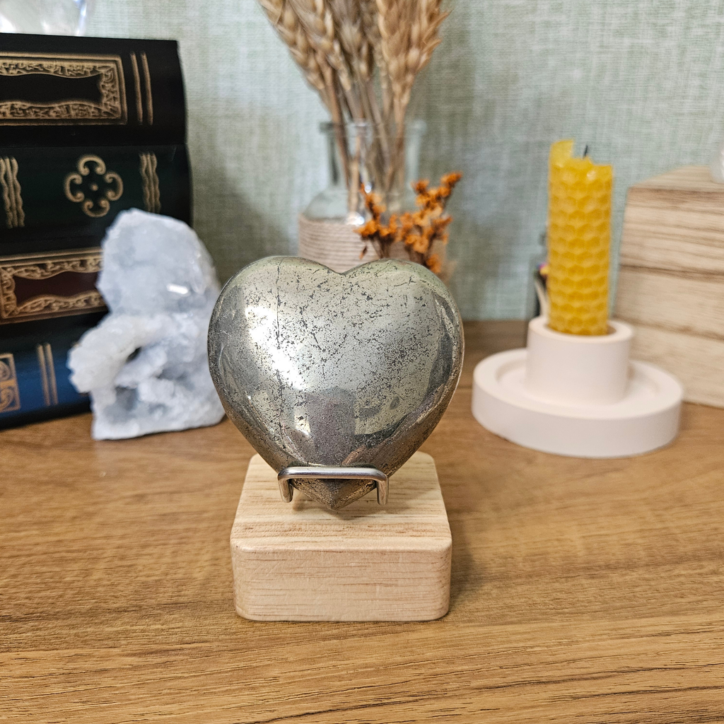 6cm polished Pyrite heart displayed upright on a wooden crystal stand.