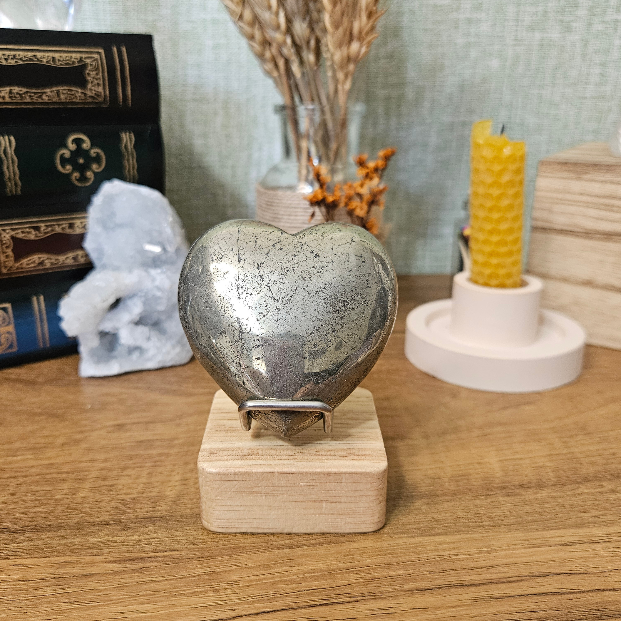 6cm polished Pyrite heart displayed upright on a wooden crystal stand.