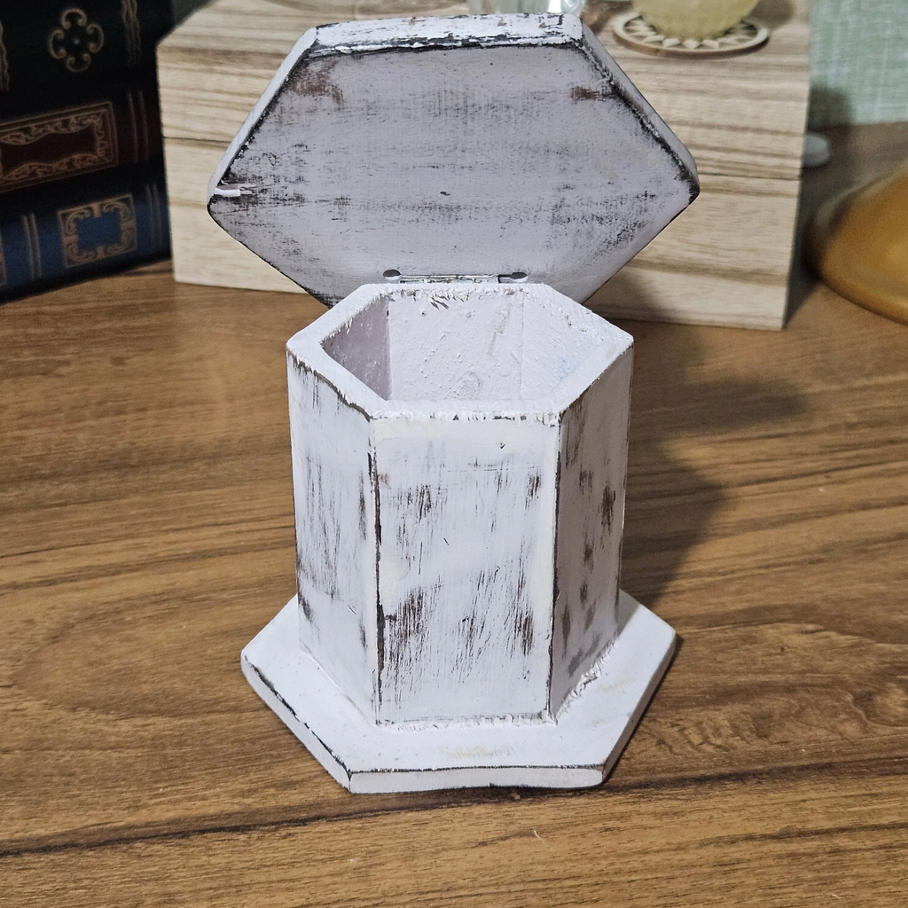Distressed white wooden incense cone burner with hexagonal base, hinged pyramid lid and decorative smoke vents.