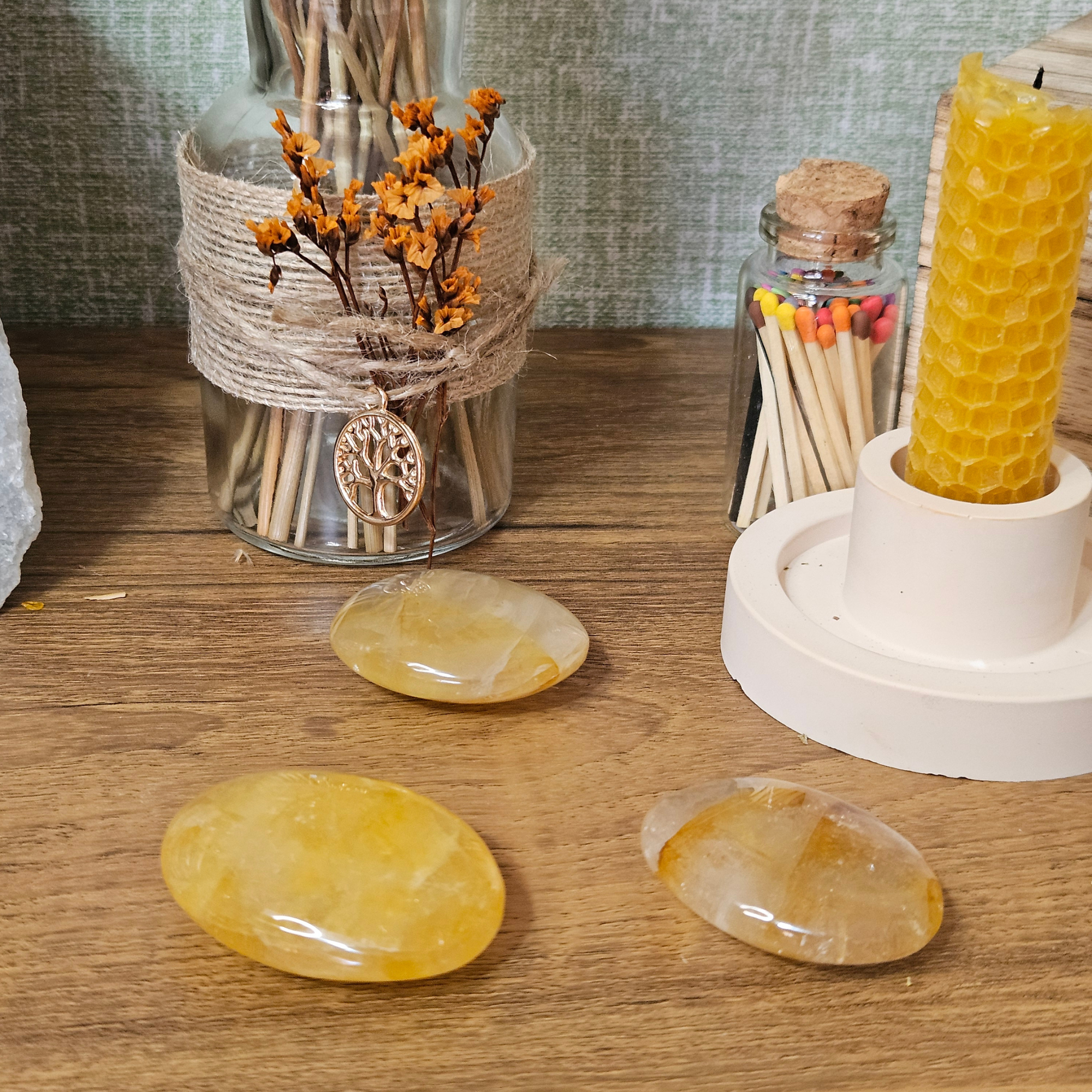 Three Golden Healer Quartz palm stones with natural yellow and golden iron inclusions.
