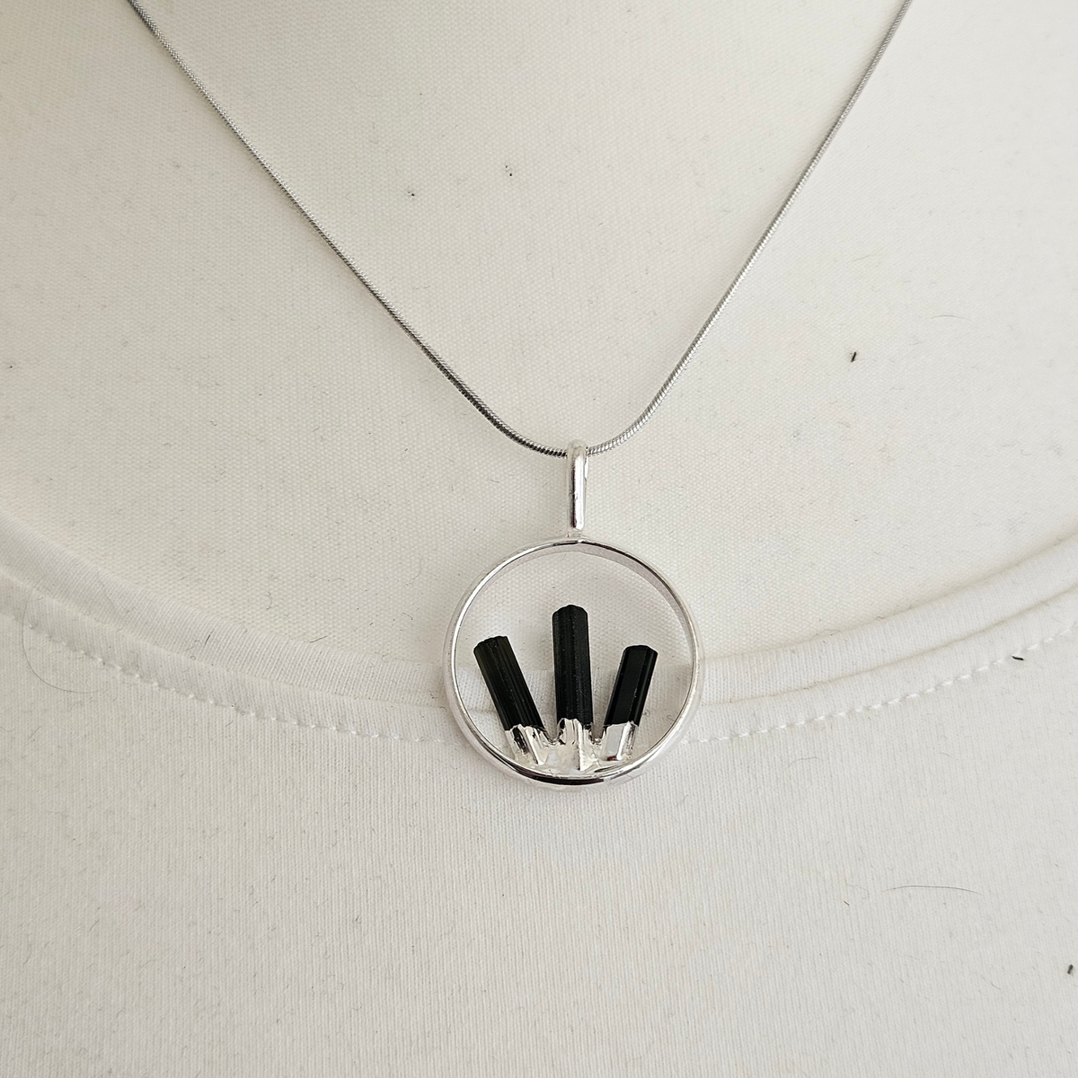 Natural Black Tourmaline crystal pendant necklace on a silver-plated chain.