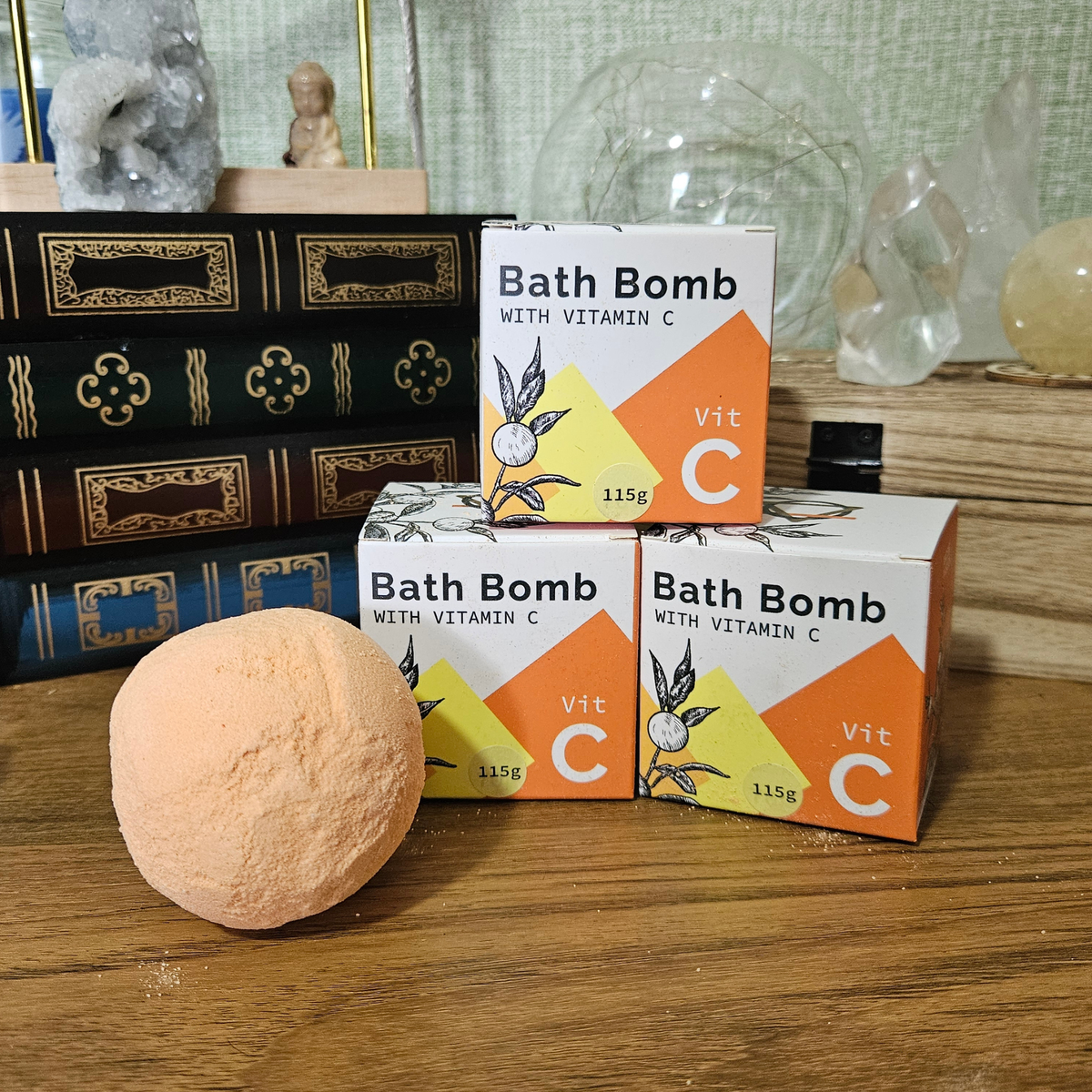 115g Vitamin C bath bomb with rosehip oil and Orange and Lemon essential oils, shown with its orange and white gift box.